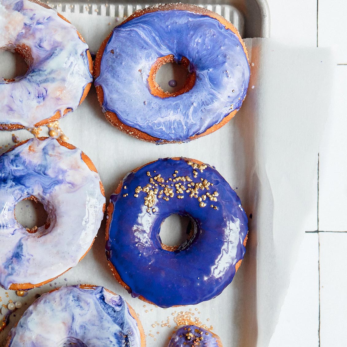 Purple donuts on white parchment paper