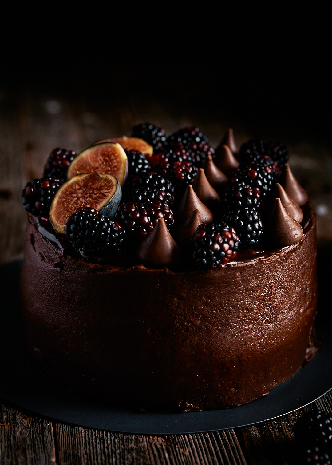 Chocolate cake with blackberries, hershey kisses, and figs on top