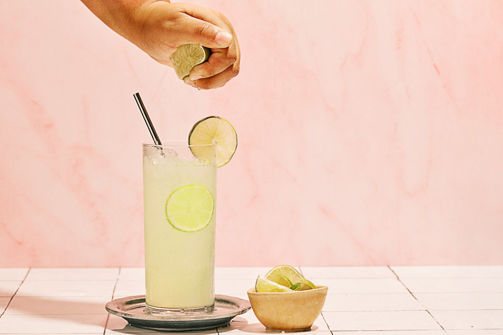 Texas Monthly Shoot of lime agua frescas against pink backdrop